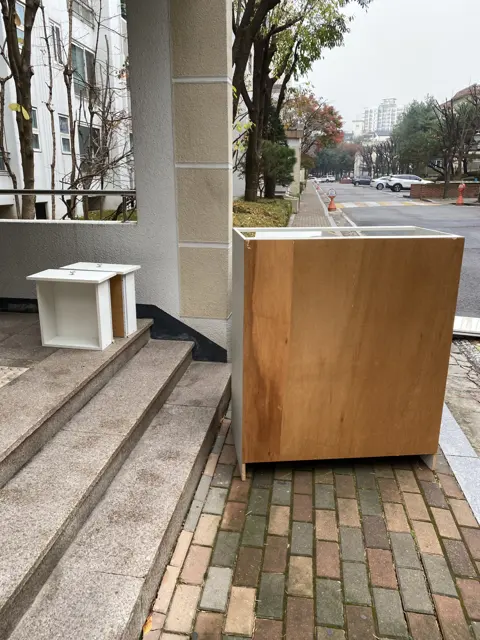 건물 밖으로 내린 판재 — 베란다 붙박이장 철거, 폐기물 수거